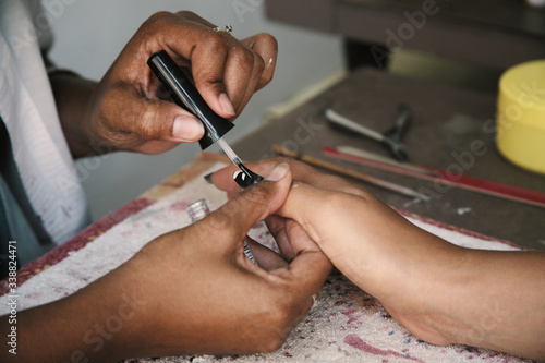 Cuban woman painting her nails