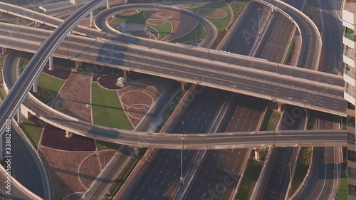 Aerial view of empty highway interchange in Dubai downtown after epidemic lockdown. Cityscapes with disappearing traffic on a bridge and streets. Roads and lanes crossroads without cars, Dubai, United photo