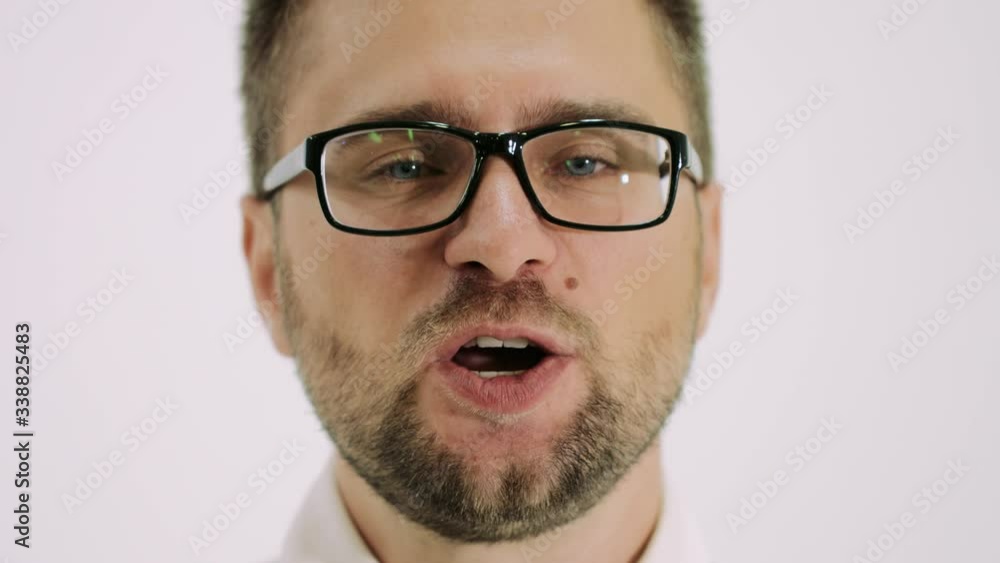 Portrait of perplexed European man 20S wearing glasses being upset and screaming Portrait of perplexed European man 20S wearing glasses being upset and screaming