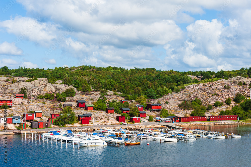 Boat harbor in front of sea cottages, Sweden.