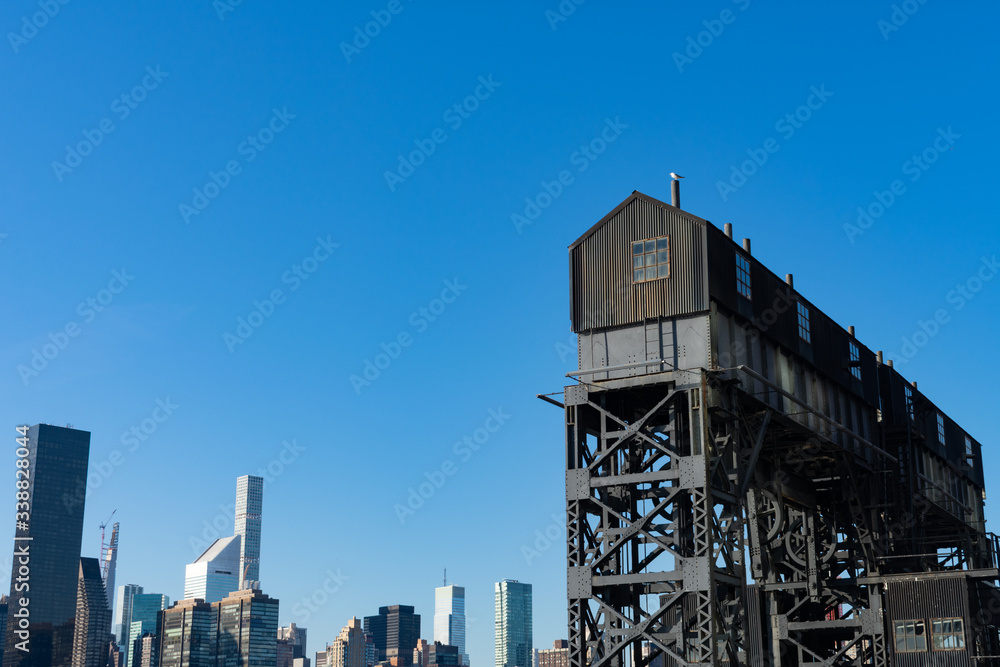 An Old Gantry with the Manhattan Skyline at Gantry Plaza State Park in Long Island City Queens An Old Gantry with the Manhattan Skyline at Gantry Plaza State Park in Long Island City Queens