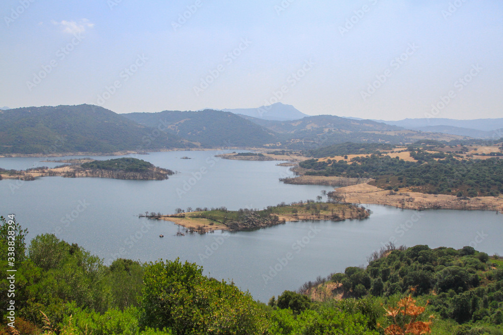 Landscape of the italian island of Sardinia in Southern Europe during summer with lake and mountains
