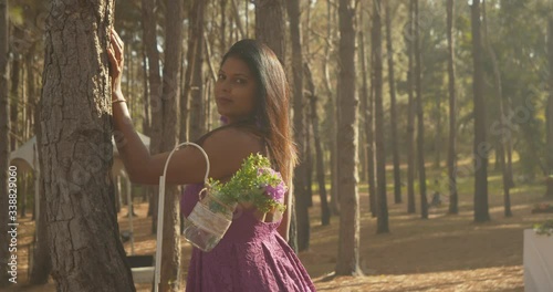 Lovely east indian model looks at the camera while her hairs blows in the wind at this outdoor wedding venue photo