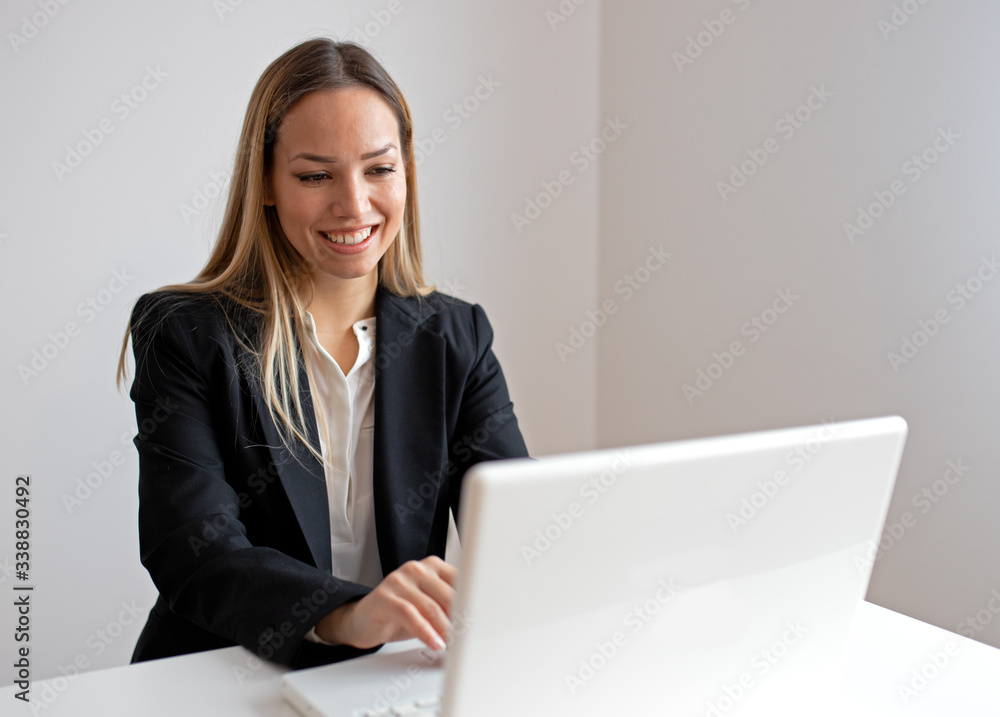 Business woman in office working on lap top Business woman in office working on lap top