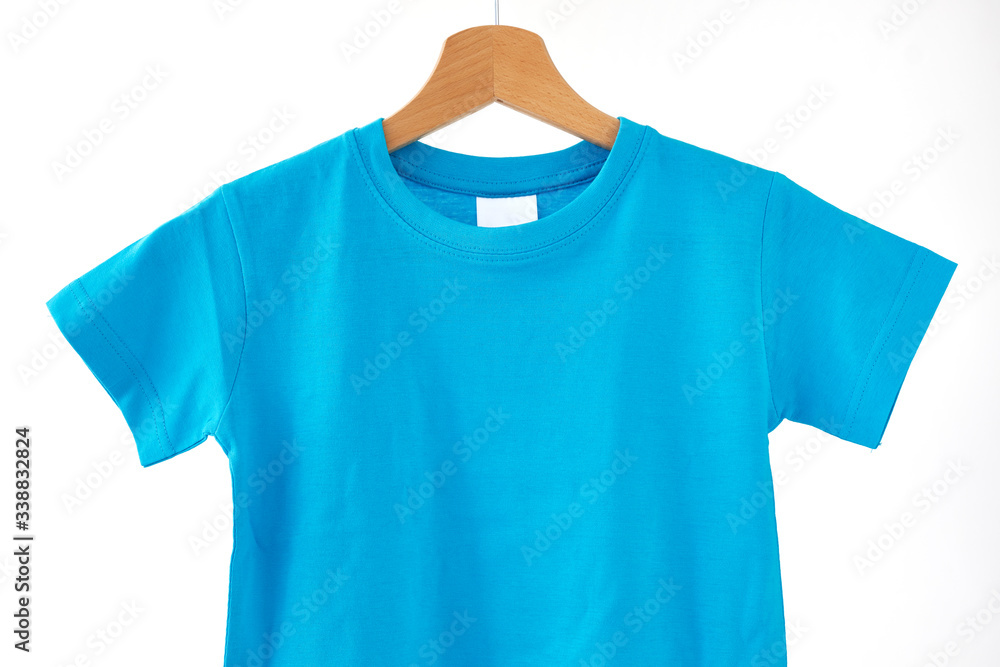 Blank blue T-Shirt mock-up hanging on white background.
Blank blue T-Shirt mock-up hanging on white background.