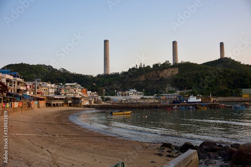 Lamma Island, Hong Kong - 12 April 2020 : Weekend travel capture, landscape of the coast next to Yung Shue Wan ferry pier at the island north, Hong Kong Electric's Lamma Power Station at the back. photo