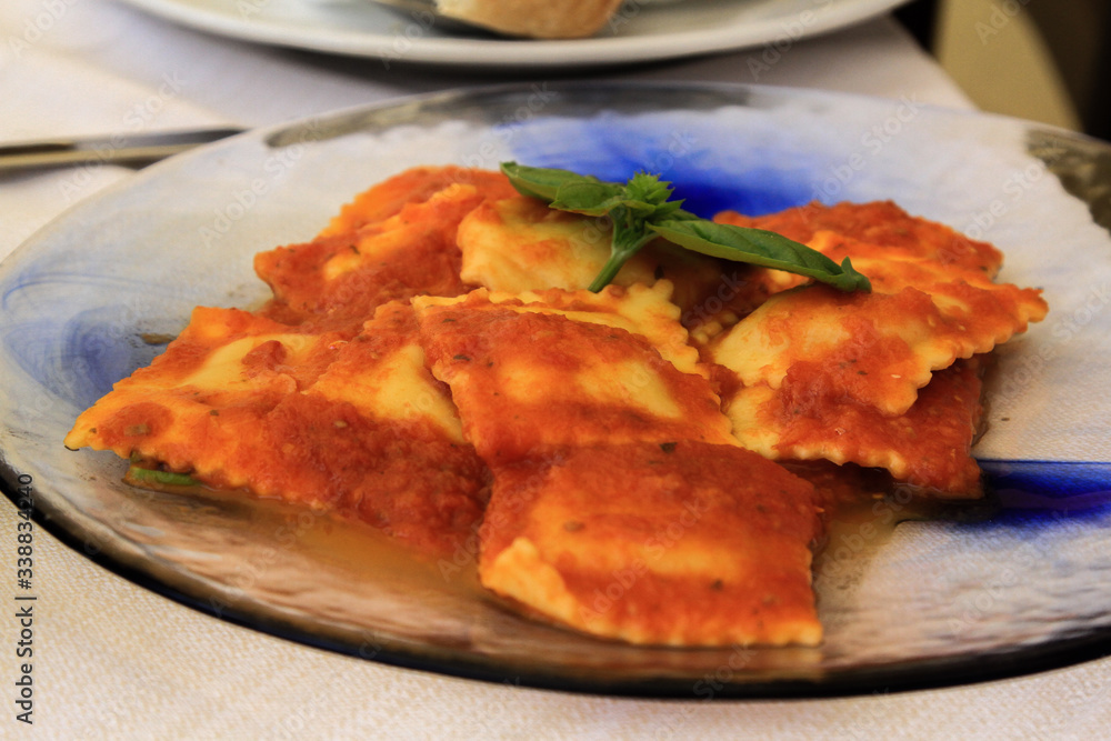 Plate of classical vegetarian ravioli pasta with tomato ragu and basil from Sardinia Plate of classical vegetarian ravioli pasta with tomato ragu and basil from Sardinia