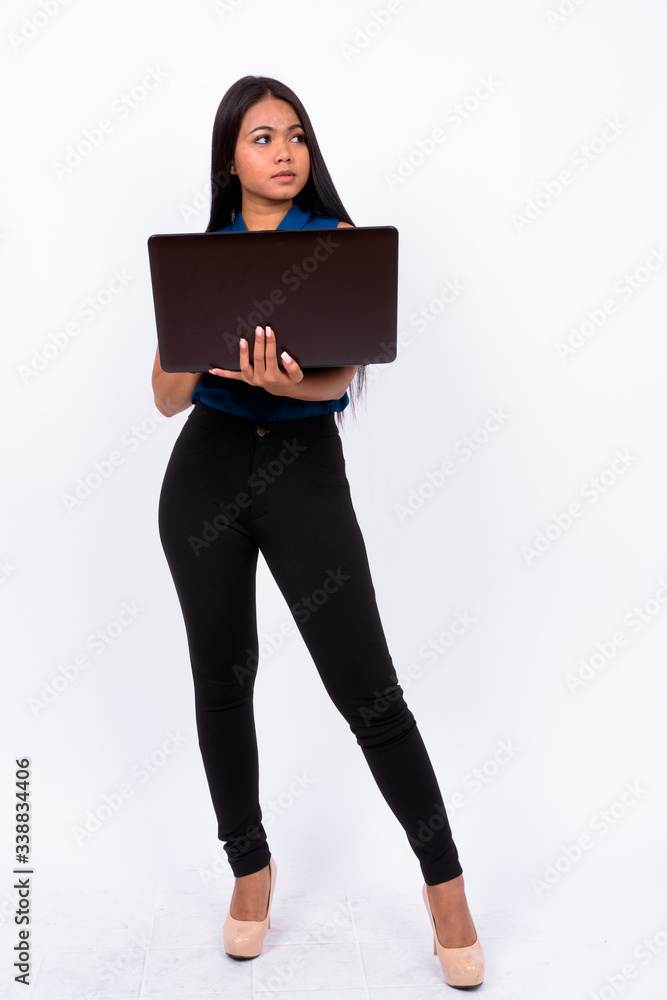 Full body shot of young Asian businesswoman using laptop Full body shot of young Asian businesswoman using laptop