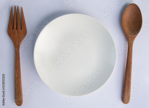 Spoon and Fork and disk on white background