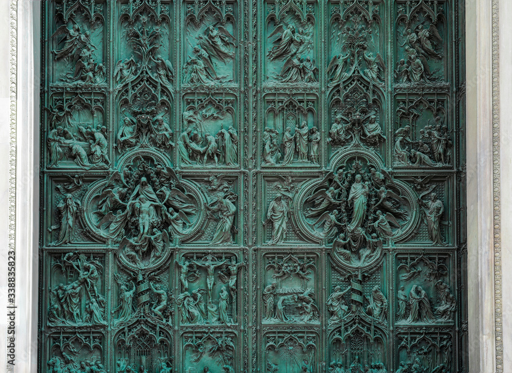 Detail bronze bas-reliefs from main door a Cathedral. Christian background.
