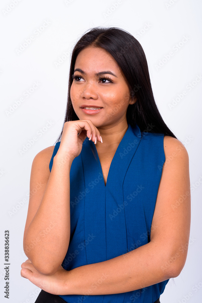 Portrait of happy young Asian businesswoman thinking Portrait of happy young Asian businesswoman thinking