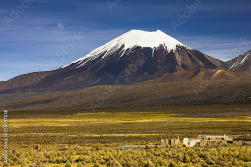 Parinacota volcano and moon - Altiplano in the Central Andes, Bolivia