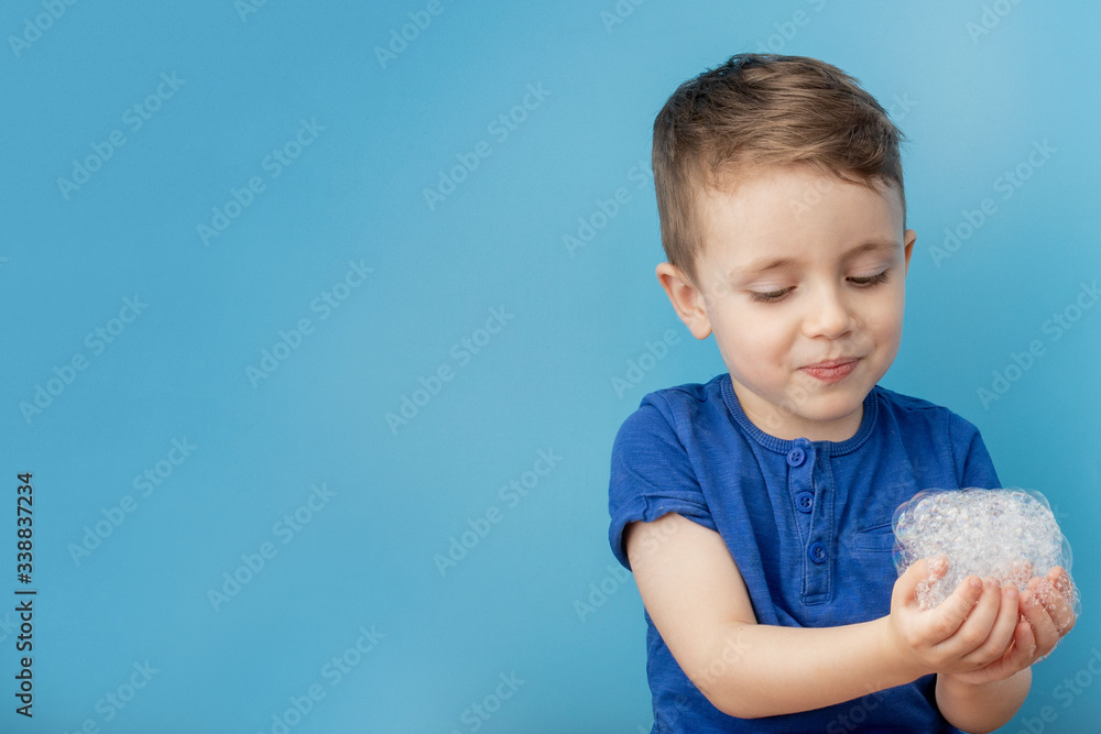 Child showing his hands with soap lather, cleaning and hygiene concept.Cleaning your hands frequently with water and soap will help prevent an epidemic from pandemic virus Child showing his hands with soap lather, cleaning and hygiene concept.Cleaning your hands frequently with water and soap will help prevent an epidemic from pandemic virus