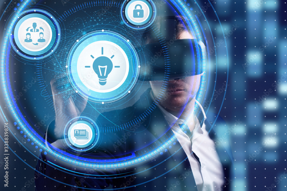 Business, Technology, Internet and network concept. Young businessman working on a virtual screen of the future and sees the inscription: Business, Technology, Internet and network concept. Young businessman working on a virtual screen of the future and sees the inscription:
