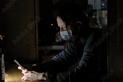 man in a medical mask at the table