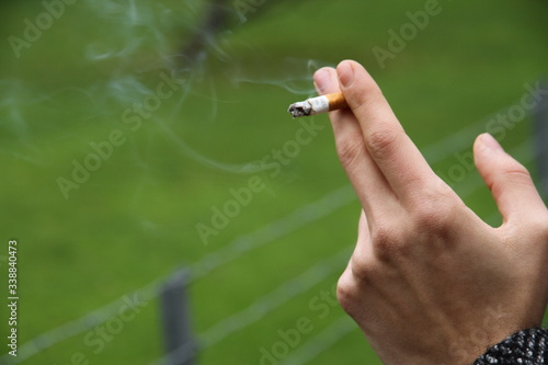 A hand of a man with a cigarette