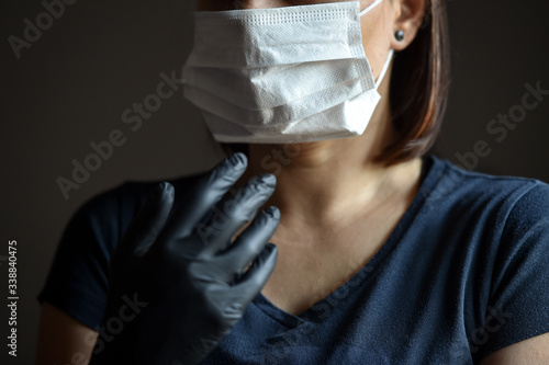 Indoors photo with unrecognizable person wearing black latex medical gloves in times of coronavirus pandemic