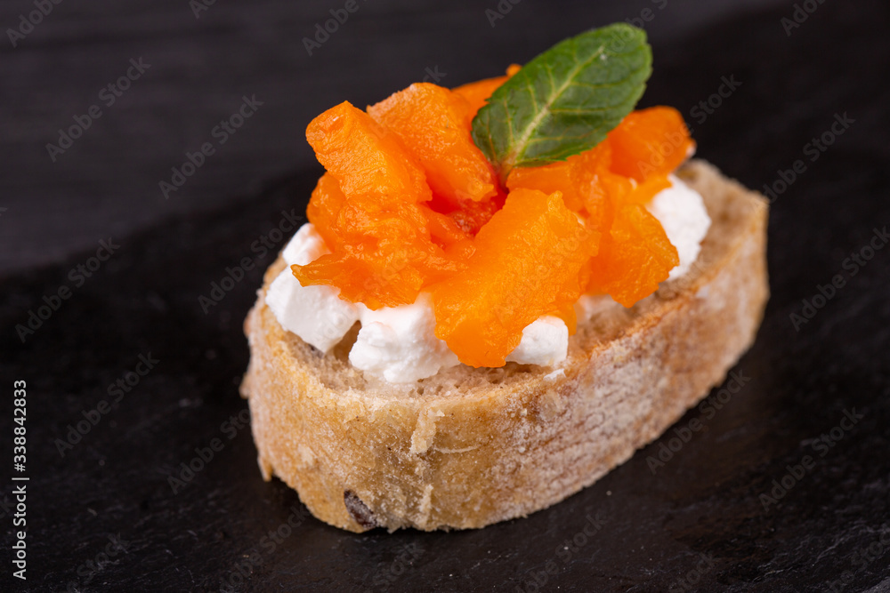 Assorty canape of toast with fish, meat and vegetables on a black background Assorty canape of toast with fish, meat and vegetables on a black background