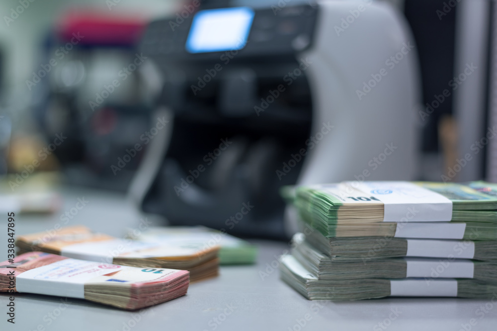 Bundles of banknotes divided into groups with currency straps placed on ...