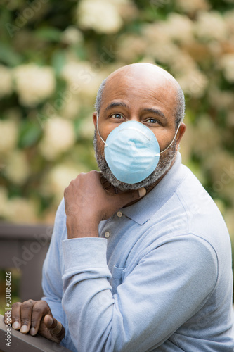 Coronavirus, portrait of African American man outside with protective mask. Concept of Lockdown, Flatten the Curve, Social Distancing, State of Emergency, Corona Virus