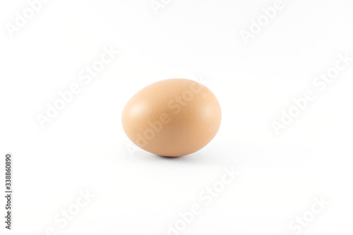 Close up of organic raw brown chicken egg isolated with white background