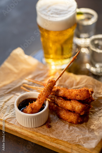 frying shrimps on wooden board with glass of beer