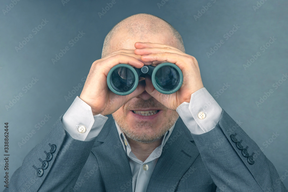 man in a business suit looks through binoculars. goals in a successful business. man in a business suit looks through binoculars. goals in a successful business.