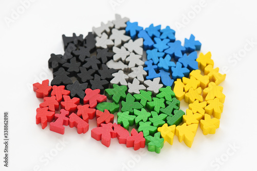 Board game parts meeples in groups concept on white backgorund