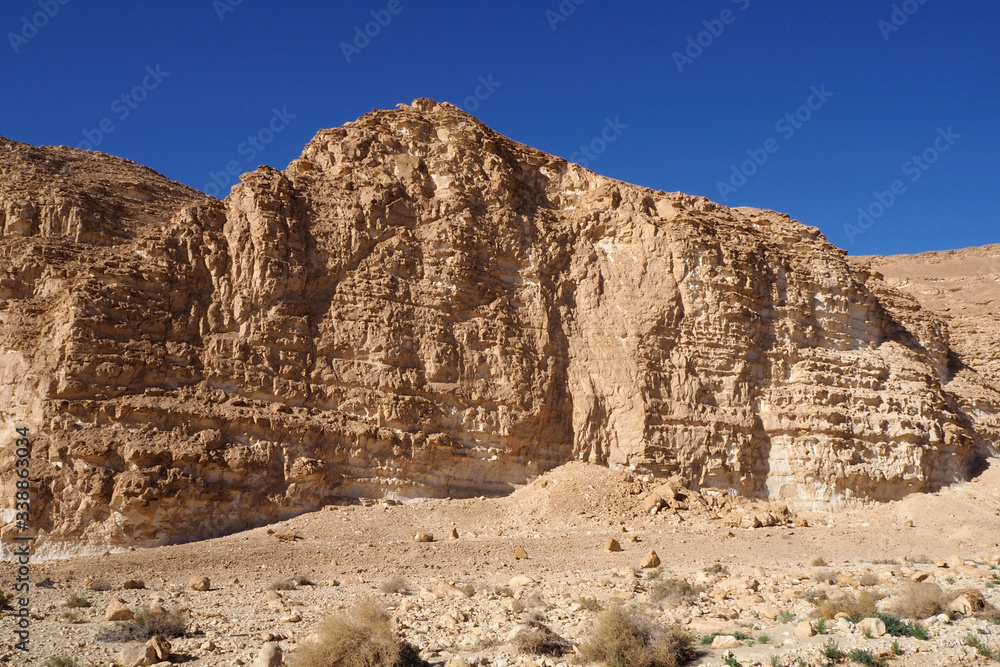 The high sandstone rock in the desert and the blue clean sky The high sandstone rock in the desert and the blue clean sky