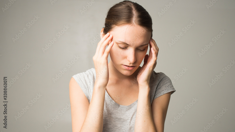Fototapeta premium Young beautiful woman having headache