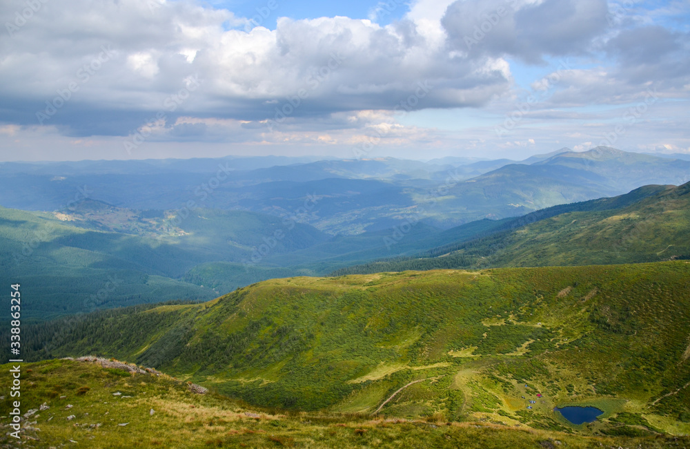 Cloudy sky and perfect look on Mountain lake Ivor and valley Dragobrat on Svydovets ridge. Carpathians, Ukraine, 