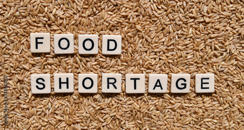 Food shortage words and forks and knives on plates with a food shortage concept.