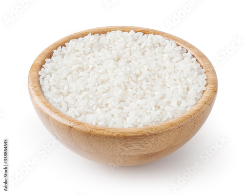 Uncooked round rice in wooden bowl isolated on white background with clipping path