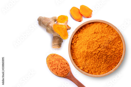 Fotografi Turmeric powder ( known as curcumin, Curcuma longa Linn) in wooden bowl and spoon with tumeric rhizome isolated on white  background