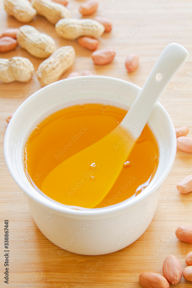 Peanut vegetable oil in a bowl close up Peanut vegetable oil in a bowl close up