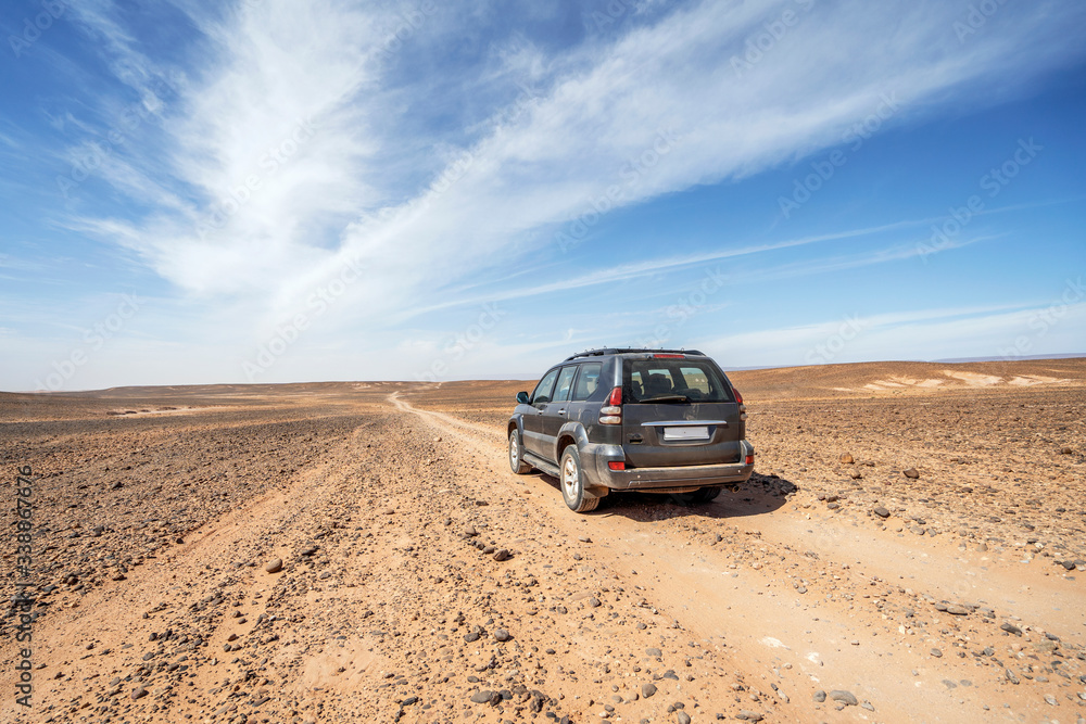Driving on dirt road through Sahara desert, Morocco Driving on dirt road through Sahara desert, Morocco