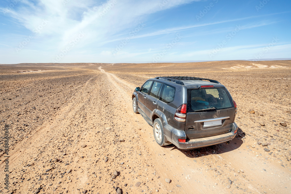 Driving on dirt road through Sahara desert, Morocco