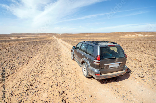 Driving on dirt road through Sahara desert, Morocco