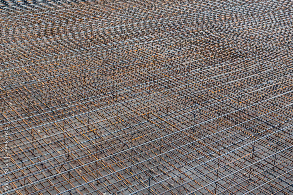 Fototapeta premium Industrial background. Reinforcement bars for pouring the foundation of a multi-story building