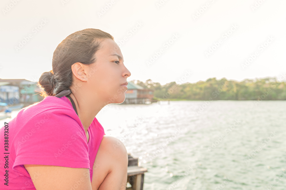 Woman looking at infinity on the riverbank