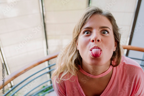 caucasian funny girl sticking out tongue