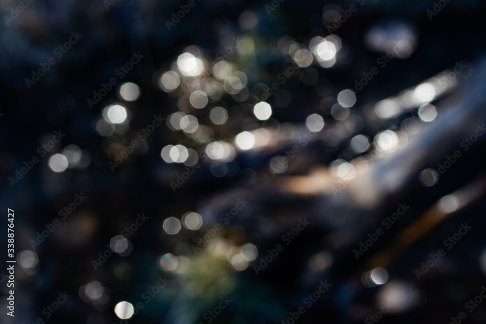 Fototapeta premium Beautiful lights bokeh reflecting from spring water.