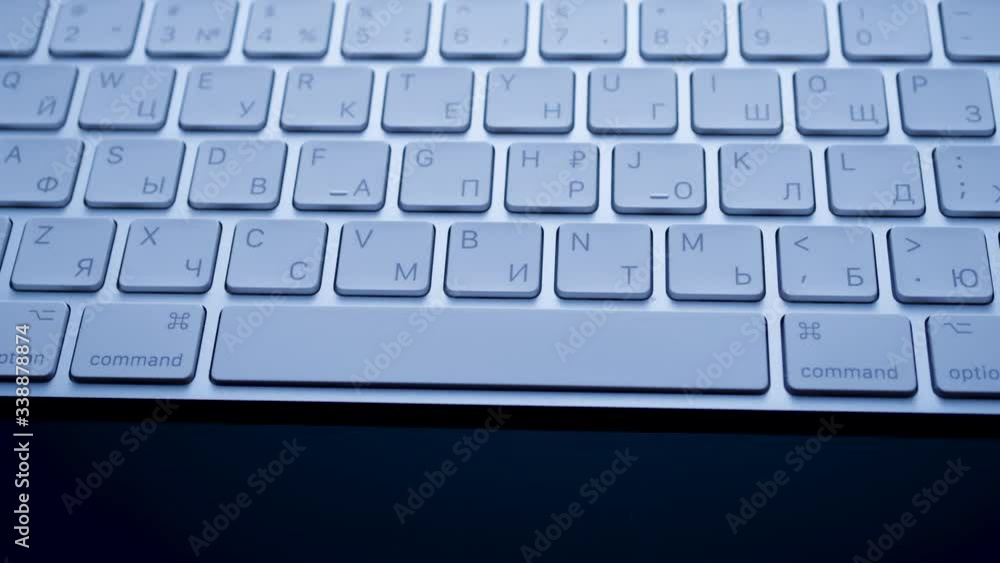 White bluetooth keyboard on a black background, modern it technology White bluetooth keyboard on a black background, modern it technology