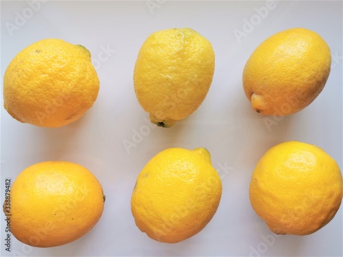 Lemons. 6 whole lemons on a white background. Top view. Fresh vitamin nutrition. Natural food. Isolated citrus fruit set