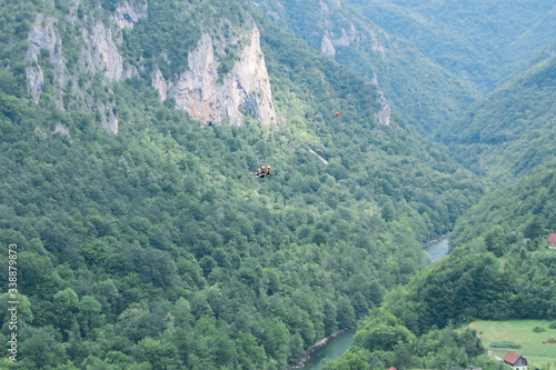 Tourists ride on the Zipline through the canyon of the Tara River Montenegro