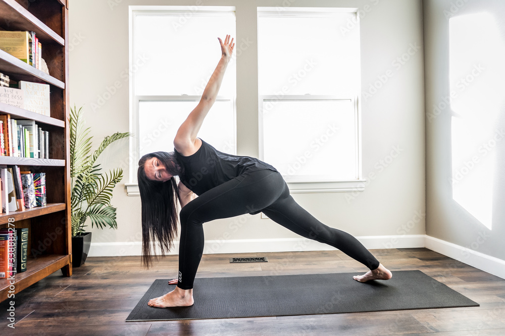 Woman doing yoga indoors at home