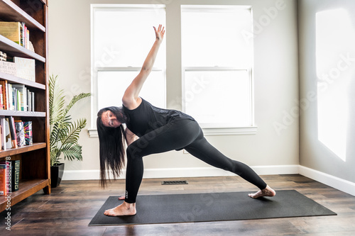 Woman doing yoga indoors at home