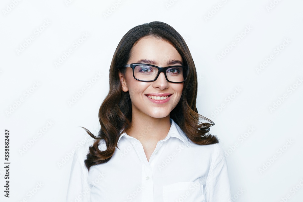 Portrait of young brunette woman with a healthy clean skin. Young beautiful business woman in stylish glasses posing in studio. Woman smiling with perfect smile and white teeth.
Portrait of young brunette woman with a healthy clean skin. Young beautiful business woman in stylish glasses posing in studio. Woman smiling with perfect smile and white teeth.