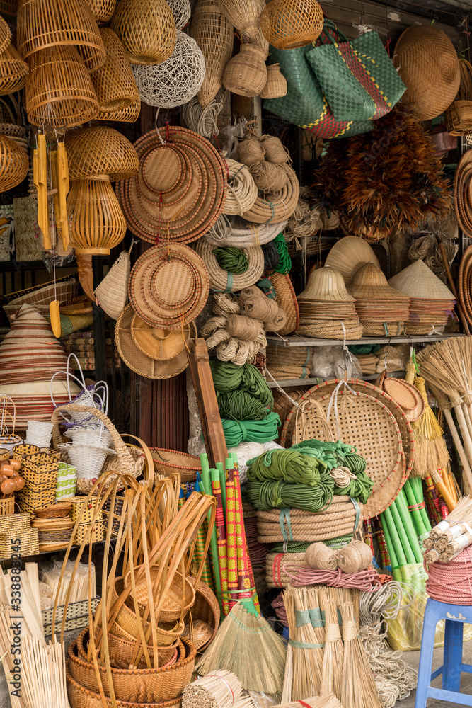 Brooms, baskets and hats for sale at a stall in the Dong Xuan Market, Hanoi, Vietnam