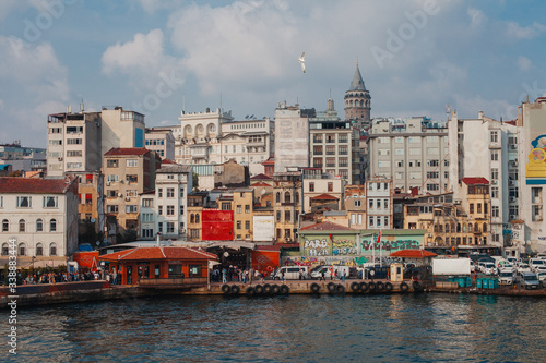 colorful urban landscape of Istanbul with houses, cars, embankment, Galata tower